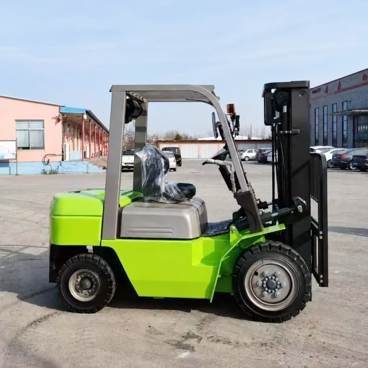 Unbranded green electric forklift truck in an industrial yard