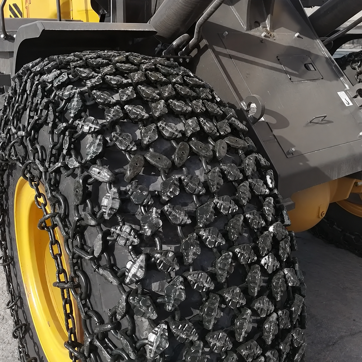 Unbranded tyre protection chains fitted to a loader tyre